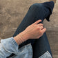 Lily Wujek wearing a stack of four Scallop Cuffs in Sterling Silver wearing blue jeans and a blue top